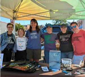 A group of library staff and volunteers at a community event