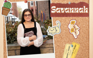 A photograph of a person holding a book on a bulletin board with stickers and the name "Savannah."