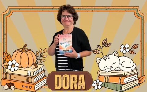 A woman stands holding a book in front of an orange and brown background with orange books, leaves and pumpkins. A cat sleeps on a pile of books.