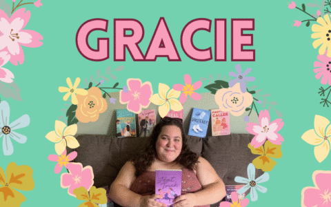 A woman with brown hair sits on a couch with books around her. The background is pastel green and there are colorful flowers on the sides and around the photo.